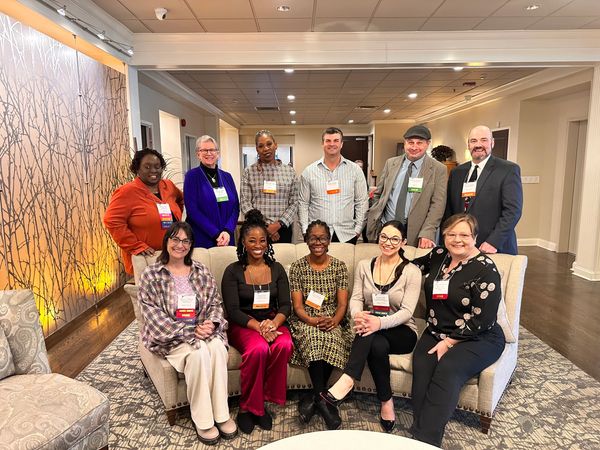 A bunch of individuals smiling at the suicide prevention conference