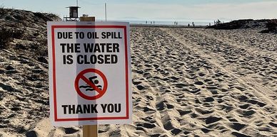 Photograph of sign signaling oil spill in Huntington Beach, California