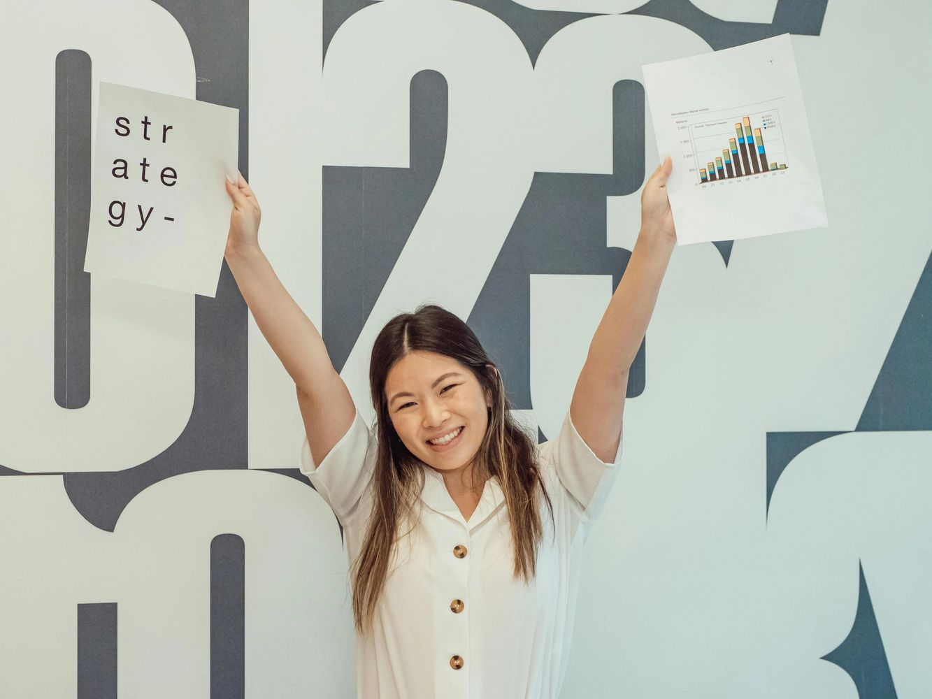 A woman celebrates her success.  Having a strategy in place is key to building and growing online.