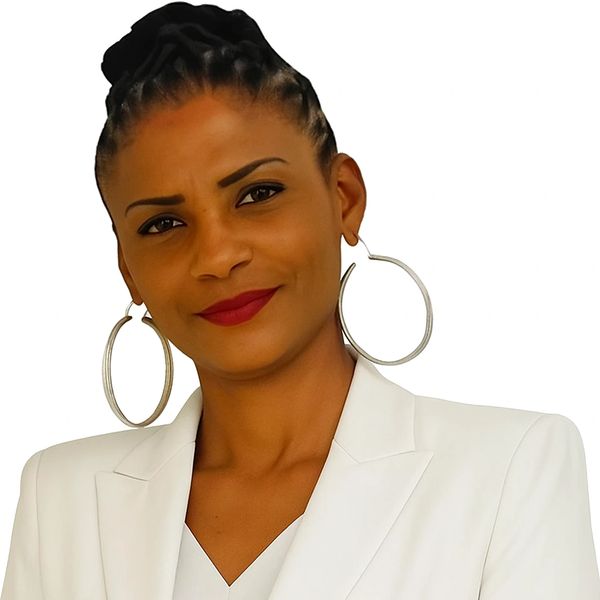 Confident woman with braided hair, wearing large hoop earrings and a white blazer.