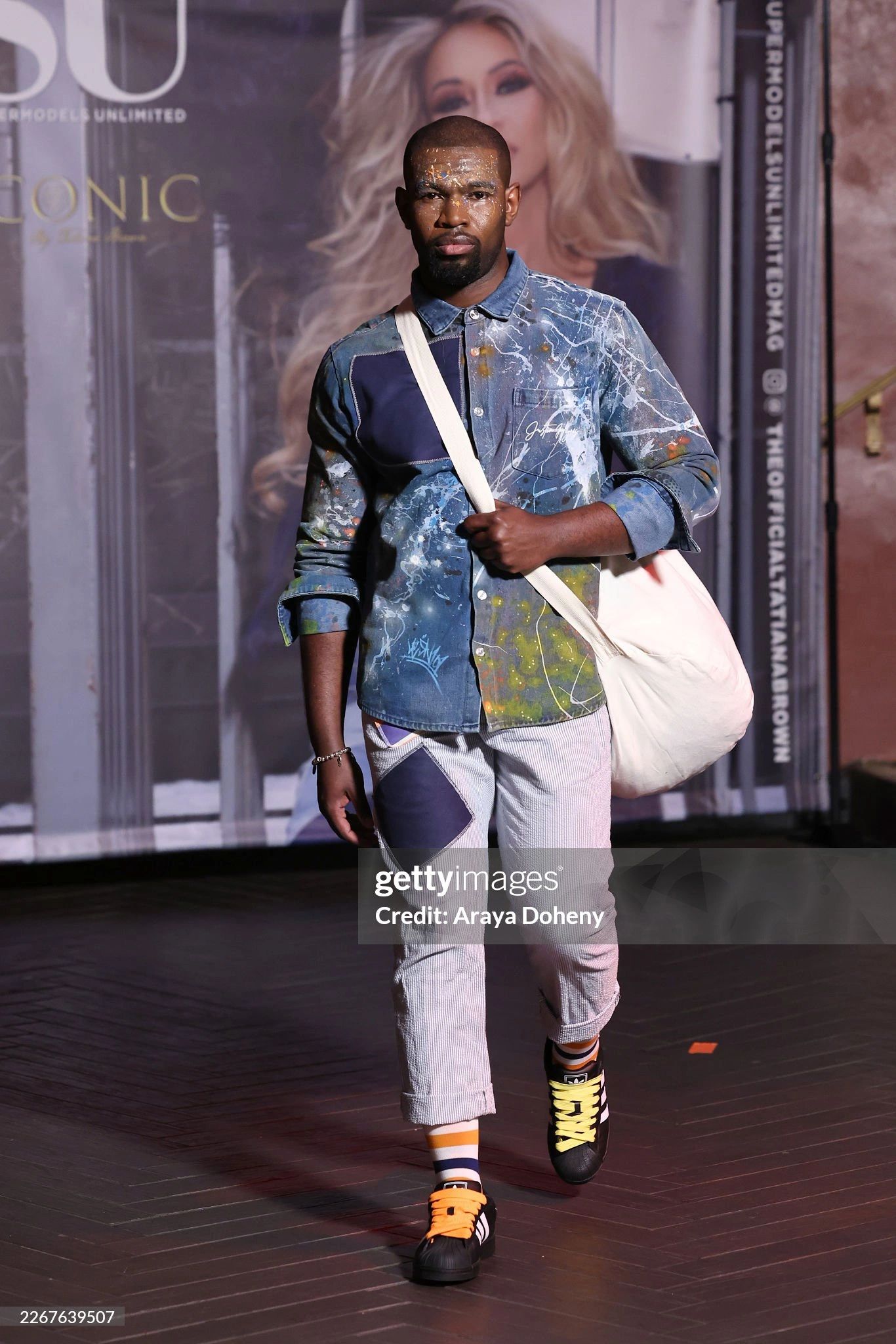 NYC fashion week model wearing custom 
Shirt collab between JUS10H and LESN101
