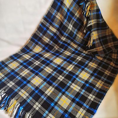 A handwoven blanket in a tartan pattern