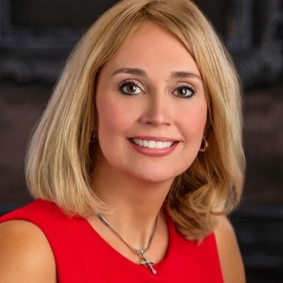 headshot of the author Michelle in red dress