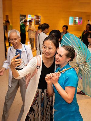 BYU Folk Dance performer with umbrella at events