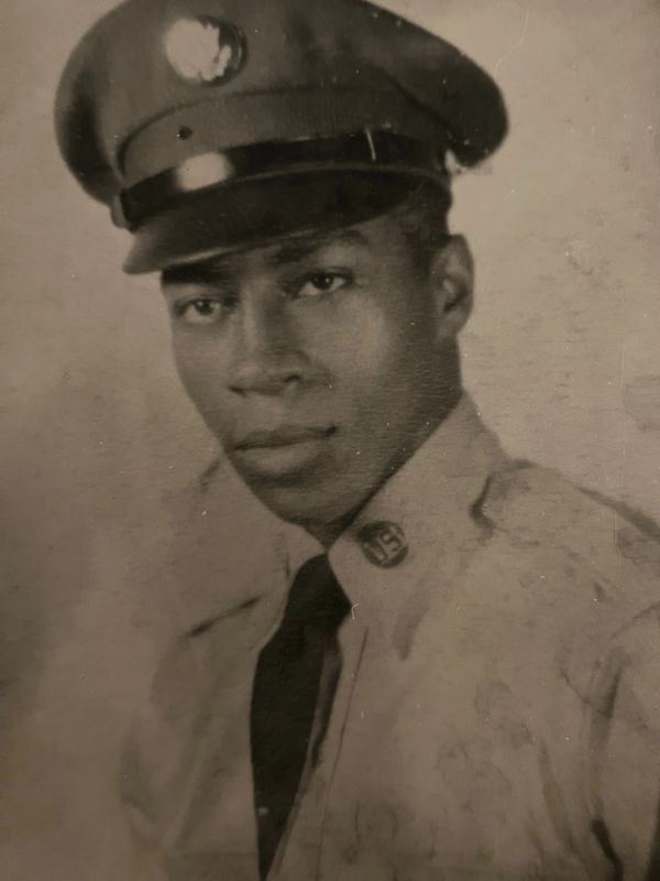 A vintage portrait of a young soldier in uniform with a serious expression.