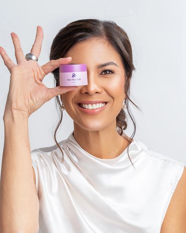 Happy perimenopause and menopause woman holding a container of eye cream