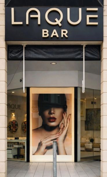 Entrance to LAQUE BAR with a large portrait.