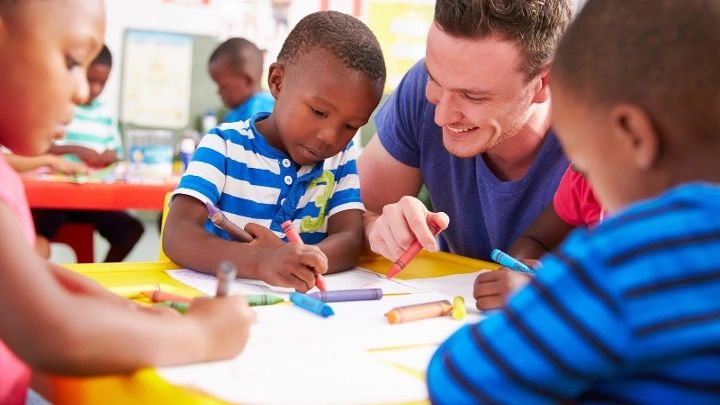 The Early Years Movement | A male Early Years teacher in a nursery working with children.