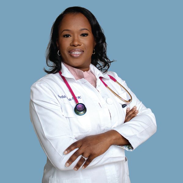 Confident female doctor with arms crossed and stethoscope.