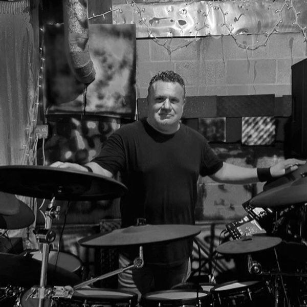 Robert standing behind his practice kit in the rehearsal room