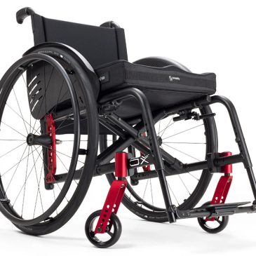A modern black and red lightweight wheelchair designed for mobility and comfort.