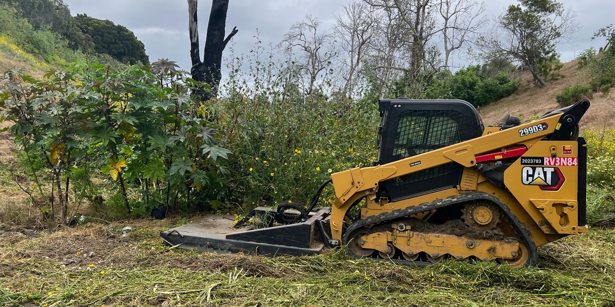 Tractor mowing weeds in malibu, ca