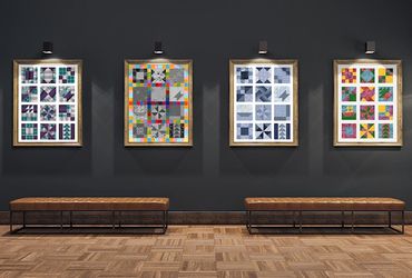 Gallery wall with four framed colorful quilt pattern artworks above benches.