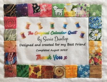 A colorful quilt label by Susie Dunlop, completed August 2025, with a patchwork border and thank you message.