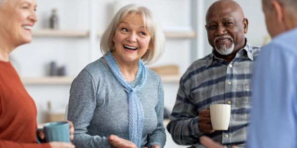 Seniors happily chatting over coffee.
