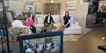 George Creative | behind-the-scenes photo of three on-camera talent seated on a showroom sofa 
