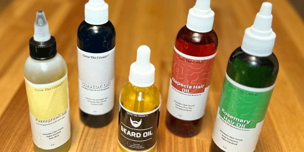 Five bottles of Grow the Crown hair oil bottles on display.