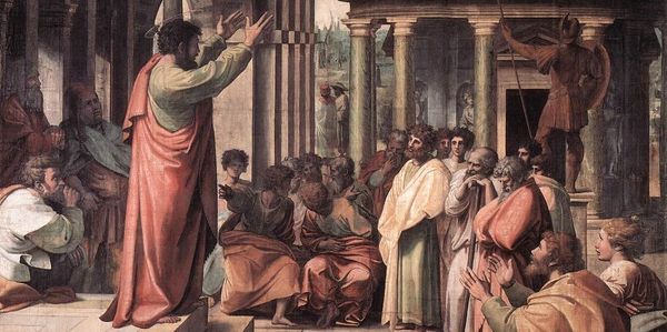 A man preaching to a group in classical attire.
