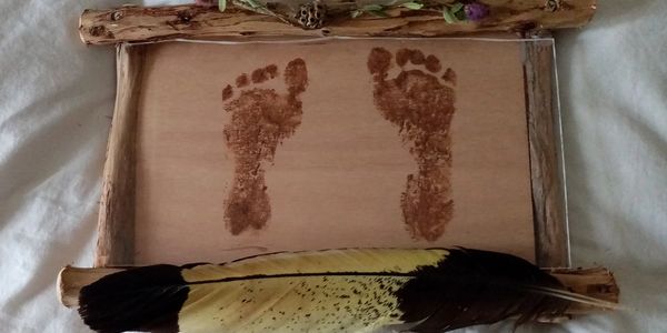 Ochre painting footprints at Aboriginal culture family ceremony at Hopkins Falls Victoria