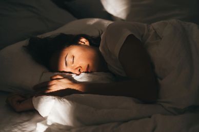 Person sleeping peacefully in bed.