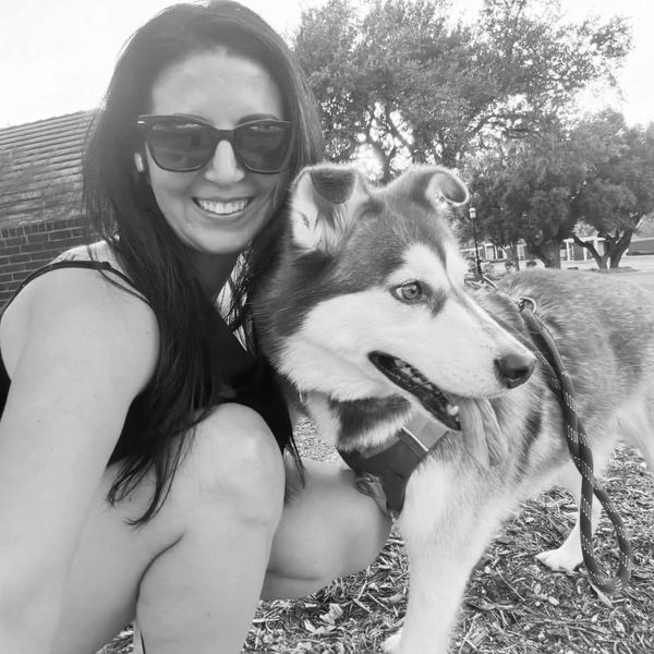 Jessica Hatchett smiling with her dog.