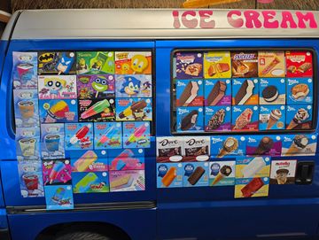 Colorful ice cream truck menu with various frozen treats and brands.