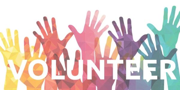 Colorful hands raised with the word 'VOLUNTEER' symbolizing community engagement.