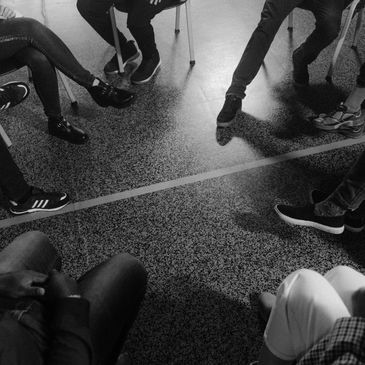 Group of people sitting in a circle. Photo by Tima Miroshnichenko