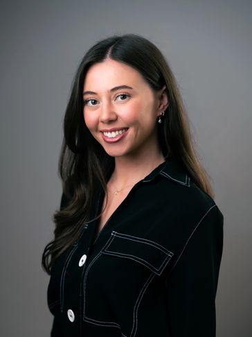 Portrait of a smiling woman with long dark hair.