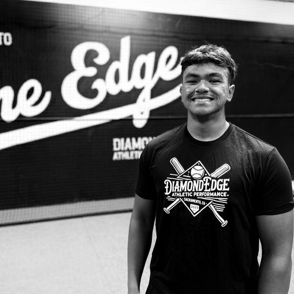 Smiling young athlete in black sports shirt.