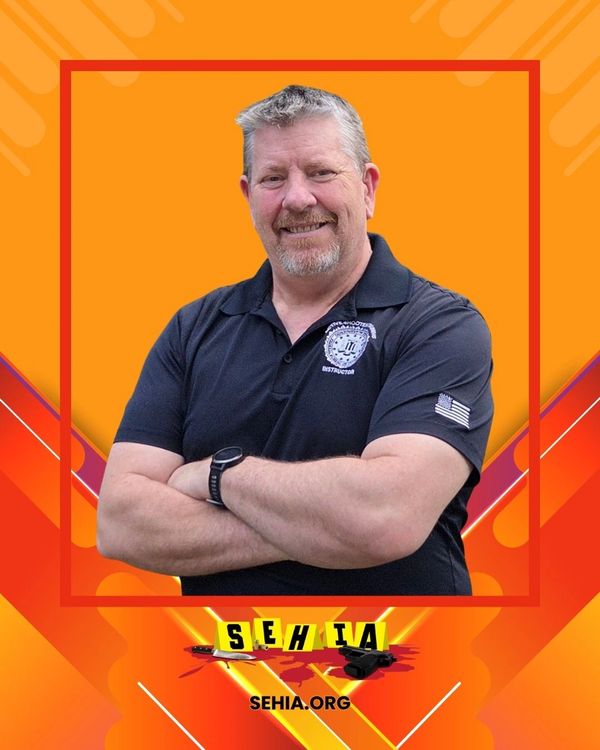 Confident man in black polo with SEHIA logo on vibrant orange background.