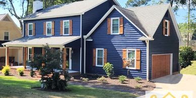 A Cut Above Painting Co. Evans GA exterior painting. Staining shutters. Faux Finish garage doors