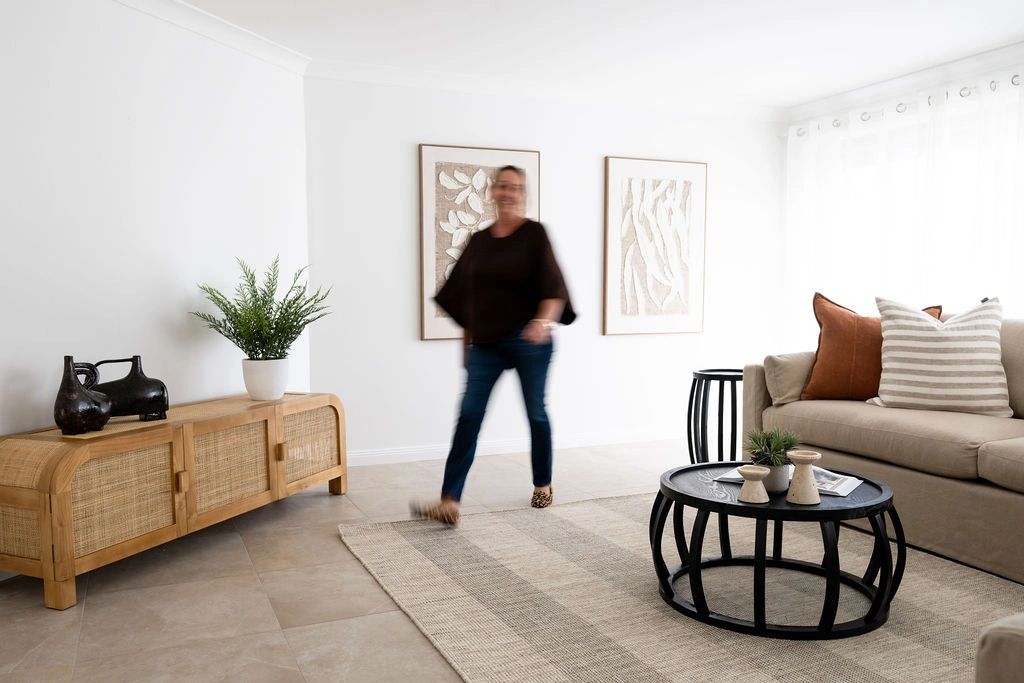 Bright living room with a beige sofa and a black coffee table.