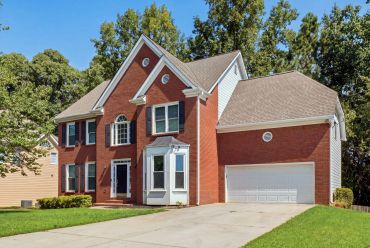 Large brick house with a two-car garage.