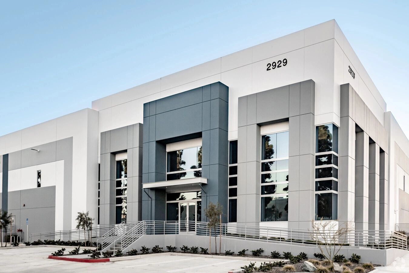 Modern commercial building with gray and white facade.