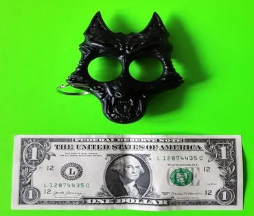 A dollar bill and black ornament