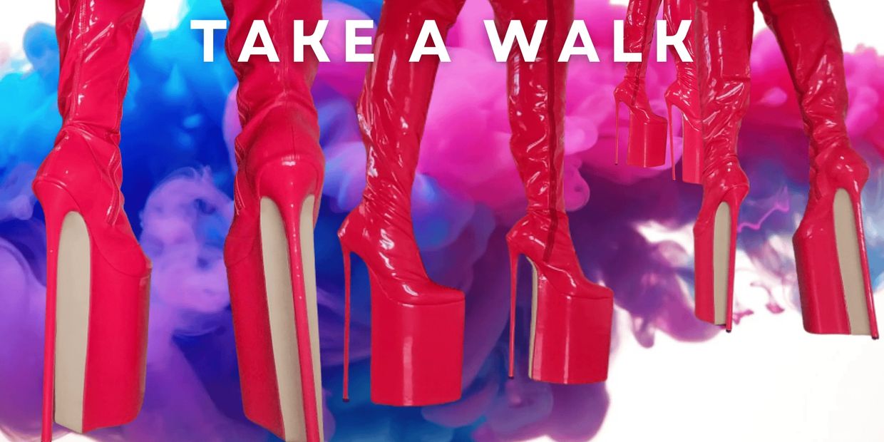 Bright red platform boots with 'TAKE A WALK' text over colorful smoky background.