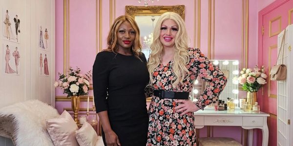 mistress ava black poses with a dressed up sissy