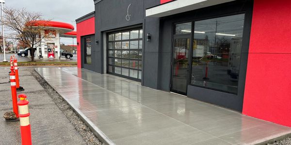 Concrete front pad and sidewalk for commercial building in St. Catharines, Ontario.