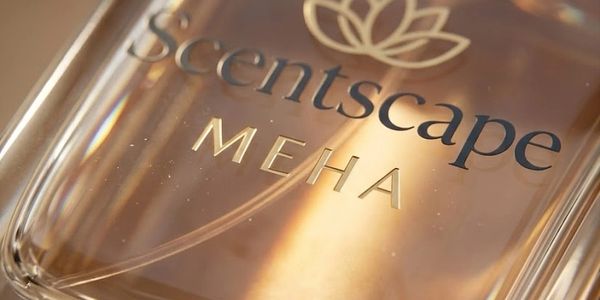 Close-up of a Scentscape MEHA fragrance bottle with warm lighting.