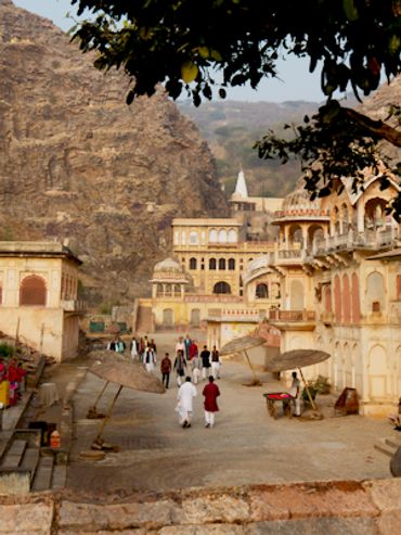 Historic Indian palace courtyard with people.