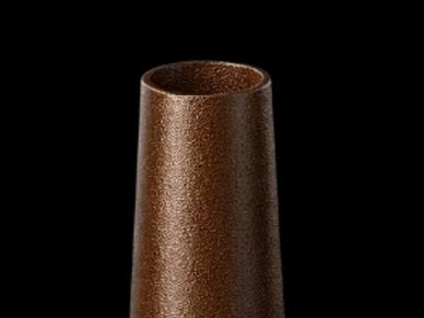 Close-up of a brown textured vase against black background.