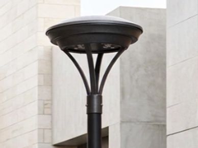 Modern black outdoor street lamp with a circular top.