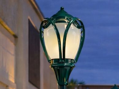 Vintage street lamp glowing at dusk.