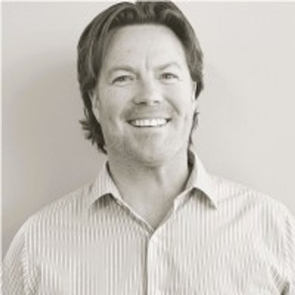 Smiling man in a striped shirt.