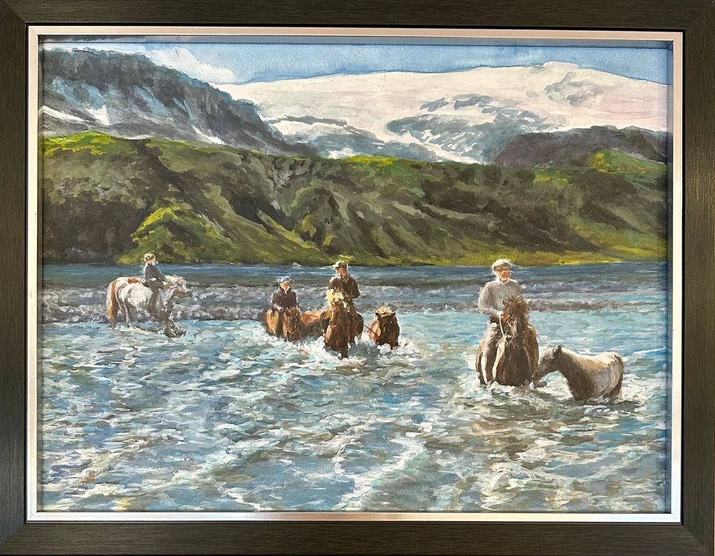 Group of horses and riders crossing a river in the mountains of Iceland.