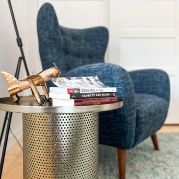 Navy blue chair with brass side table