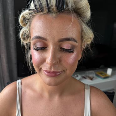 Woman with closed eyes and styled hair.