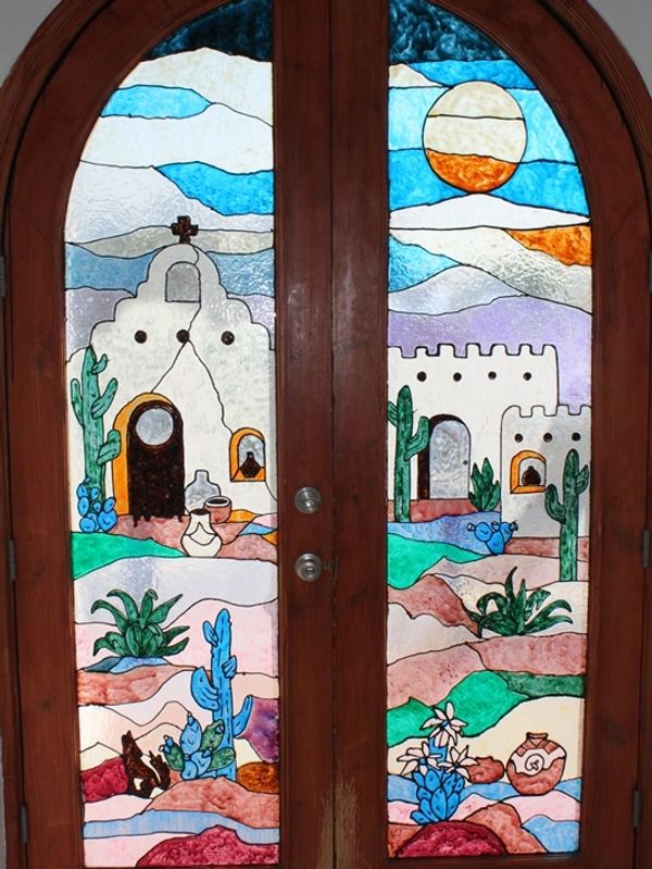 The stain glass window front door welcomes you into the home with a bedroom and bathroom immediately