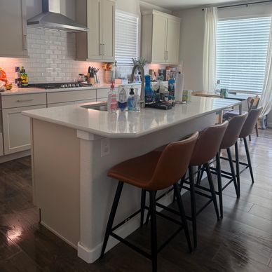 Modern kitchen with island and bar stools.